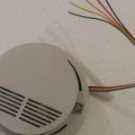 How do you change the battery in your smoke detectors with cable connection